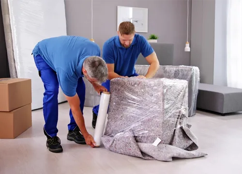 Professionals expertly packing belongings with care for the move.